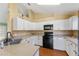Bright kitchen with white cabinets and black appliances at 1921 Nicholas Pl, St Cloud, FL 34771