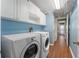 Laundry room with washer, dryer, and ample cabinet space at 1921 Nicholas Pl, St Cloud, FL 34771