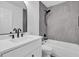 Modern bathroom with gray tile and white vanity at 1000 Lake Of The Woods Blvd # 203E, Casselberry, FL 32730