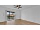 Bedroom with hardwood floors and sliding glass door to balcony at 1000 Lake Of The Woods Blvd # 203E, Casselberry, FL 32730