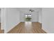 Bright, airy living room with sliding glass doors to the outside has wood-look floors and ceiling fan at 1000 Lake Of The Woods Blvd # 203E, Casselberry, FL 32730