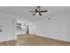 Living room with wood-look floors is brightly lit and adjacent to the updated kitchen with stainless appliances at 1000 Lake Of The Woods Blvd # 203E, Casselberry, FL 32730