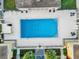 Aerial view of sparkling blue community pool and sun deck at 1000 Lake Of The Woods Blvd # 203E, Casselberry, FL 32730