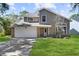 Two-story house with a large front yard and attached garage at 11172 Cypress Leaf Drive, Orlando, FL 32825