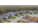 Aerial view of houses with solar panels and tree-lined landscape at 1176 Liberty Hall Dr, Kissimmee, FL 34746