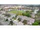 Aerial view of townhomes in a well-maintained community with nearby grassy field at 1216 Priory Cir, Winter Garden, FL 34787