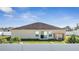 View of the back of house with a white fence, a yard, and sliding glass doors at 1317 Conch Key Ln, Davenport, FL 33837