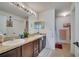 Bright bathroom featuring double sinks, a large mirror, and ample cabinet storage at 1317 Conch Key Ln, Davenport, FL 33837