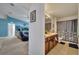 Bathroom with double sinks, wooden cabinetry and shower with curtains at 1317 Conch Key Ln, Davenport, FL 33837