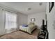 Cozy bedroom with neutral walls, carpet flooring, and a comfortable bed with a blue blanket at 1317 Conch Key Ln, Davenport, FL 33837