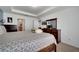 Bright main bedroom features a bed with a decorative headboard and dresser at 1317 Conch Key Ln, Davenport, FL 33837