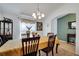This stylish dining room features a modern light fixture and a decorative wine rack at 1317 Conch Key Ln, Davenport, FL 33837