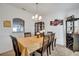 Bright dining room features a modern light fixture, wine rack and cabinet for glassware at 1317 Conch Key Ln, Davenport, FL 33837