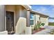 Covered front entrance with brown columns and a matching front door at 1317 Conch Key Ln, Davenport, FL 33837