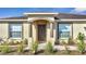 Charming front entrance featuring decorative columns, and a well-manicured lawn at 1317 Conch Key Ln, Davenport, FL 33837