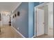 Inviting hallway with decorative wall accents and neutral tile flooring that connects different living spaces at 1317 Conch Key Ln, Davenport, FL 33837