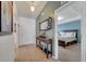 Hallway view leading to a bedroom, featuring a modern mirror and decorative table at 1317 Conch Key Ln, Davenport, FL 33837