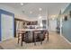 Open kitchen featuring an island with seating, stainless steel appliances, and dark cabinetry with plenty of storage space at 1317 Conch Key Ln, Davenport, FL 33837