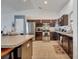 Spacious kitchen featuring stainless steel appliances, dark cabinetry, and a convenient center island with seating at 1317 Conch Key Ln, Davenport, FL 33837