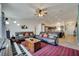 Open living room with ceiling fan, sofa and adjacent kitchen at 1317 Conch Key Ln, Davenport, FL 33837
