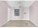 Empty bedroom featuring a window and ceiling fan at 1350 Palm Dr, Mount Dora, FL 32757