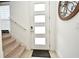 Front entry with modern door, stairs, and decorative wall art at 1389 Captiva Cv # 20, Sanford, FL 32771