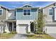 Two-story townhome with neutral siding and a paved driveway at 1389 Captiva Cv # 20, Sanford, FL 32771
