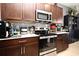 Modern kitchen with stainless steel appliances and dark cabinets at 1389 Captiva Cv # 20, Sanford, FL 32771