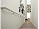 Carpeted stairs with white railing and wall decor at 1389 Captiva Cv # 20, Sanford, FL 32771