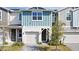 Modern townhouse exterior with light gray, blue, and stone accents at 1389 Captiva Cv # 20, Sanford, FL 32771