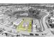 Black and white aerial view of a home with a well-manicured lawn in a residential neighborhood at 1511 Goblet Cove St, Kissimmee, FL 34746