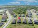 An aerial view of homes in a well-maintained neighborhood with lush green lawns and mature trees at 1511 Goblet Cove St, Kissimmee, FL 34746