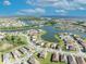 Scenic aerial view of a waterfront community with beautifully landscaped homes and blue skies at 1511 Goblet Cove St, Kissimmee, FL 34746