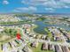 Aerial view of a waterfront community with single-Gathering homes and lush landscaping at 1511 Goblet Cove St, Kissimmee, FL 34746