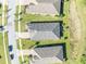 An aerial view showcases this homes roof, landscaping and positioning on the street at 1511 Goblet Cove St, Kissimmee, FL 34746