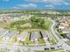 An aerial view showcases this homes roof, landscaping, surrounding neighborhood, nearby community features, and lake views at 1511 Goblet Cove St, Kissimmee, FL 34746