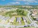 An aerial view showcases this homes roof, landscaping, surrounding neighborhood, nearby community features, and lake views at 1511 Goblet Cove St, Kissimmee, FL 34746