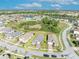 An aerial view of a residential neighborhood featuring well-manicured lawns and sidewalks at 1511 Goblet Cove St, Kissimmee, FL 34746