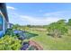 Expansive backyard featuring lush greenery, palm trees, and a paver patio with scenic views at 1511 Goblet Cove St, Kissimmee, FL 34746