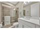 Bathroom with white cabinet, quartz counters, modern sink, and glass-enclosed shower with gray tile at 1511 Goblet Cove St, Kissimmee, FL 34746