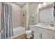 Bathroom with white cabinet, quartz counters, modern sink, and tub with light blue tile at 1511 Goblet Cove St, Kissimmee, FL 34746