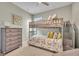 Bright bedroom featuring a bunk bed, a dresser, and tasteful decor creating a cozy and functional living space at 1511 Goblet Cove St, Kissimmee, FL 34746