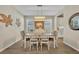 Elegant dining room with a stylish chandelier, neutral color scheme, and seamless flow into other living areas at 1511 Goblet Cove St, Kissimmee, FL 34746