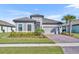 Charming single-story home with a tile roof, paver driveway, well-manicured lawn, and lush landscaping at 1511 Goblet Cove St, Kissimmee, FL 34746