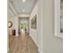 Inviting hallway with tile flooring, neutral walls, decorative accents, and views into the adjacent living spaces at 1511 Goblet Cove St, Kissimmee, FL 34746