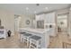 Well-lit kitchen showcasing a center island with seating, stainless steel appliances, and white cabinets at 1511 Goblet Cove St, Kissimmee, FL 34746