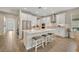 Bright kitchen featuring a large island with seating, stainless steel appliances, and modern white cabinetry at 1511 Goblet Cove St, Kissimmee, FL 34746