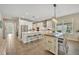 Spacious kitchen with white cabinets, stainless appliances, and a large island with barstool seating at 1511 Goblet Cove St, Kissimmee, FL 34746