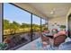 Outdoor lanai featuring a seating area with comfortable chairs, a table, and a view of the backyard at 1511 Goblet Cove St, Kissimmee, FL 34746