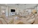 Inviting living room showcasing tile floors, comfortable seating, and a seamless transition to the kitchen at 1511 Goblet Cove St, Kissimmee, FL 34746